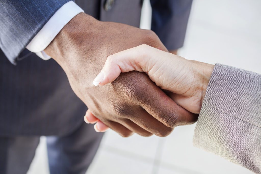 Businessman or man shaking hands with a businesswoman. A colleague making a business deal